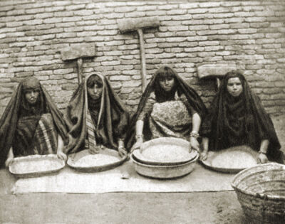 Arab women crushing ice in Baghdad, Iraq