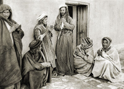 The Mullah teaching a prayer to a young man in Iraq