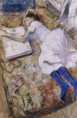 A Young Girl Stretched Out And Looking at An Album